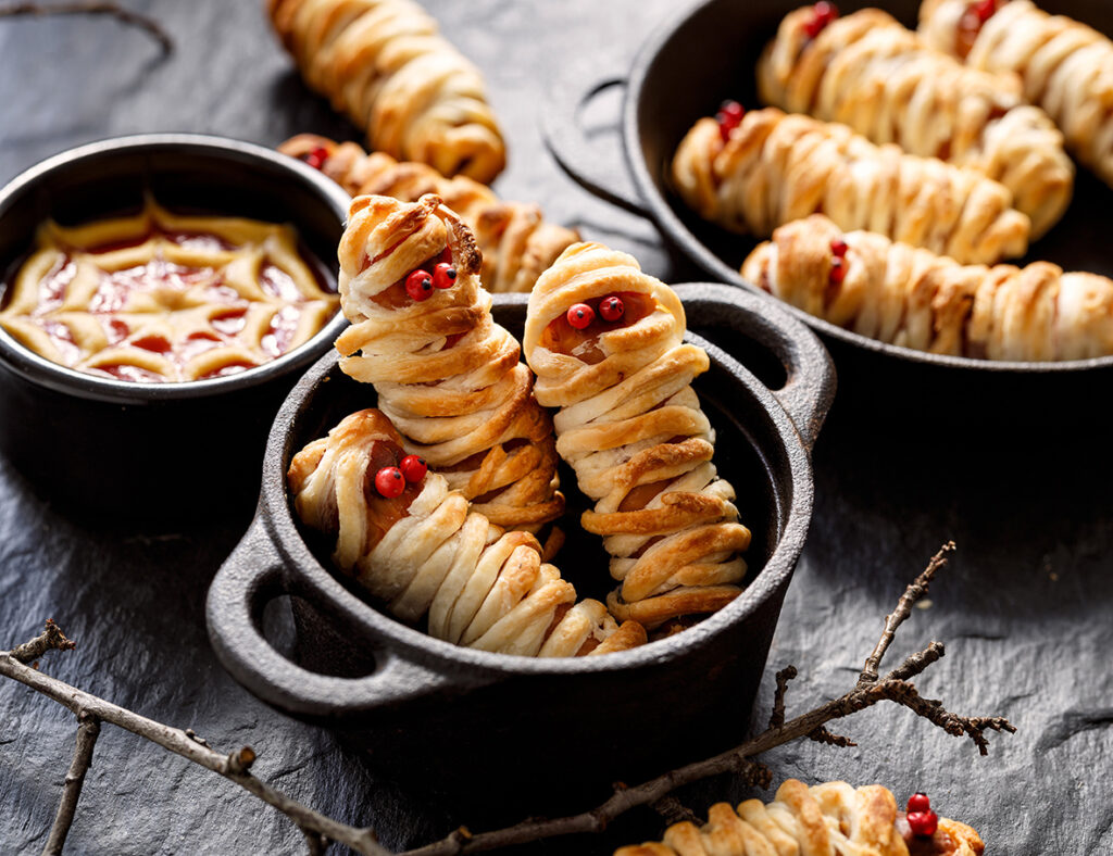 Mummy dogs made with sausages and redcurrant eyes Halloween party food