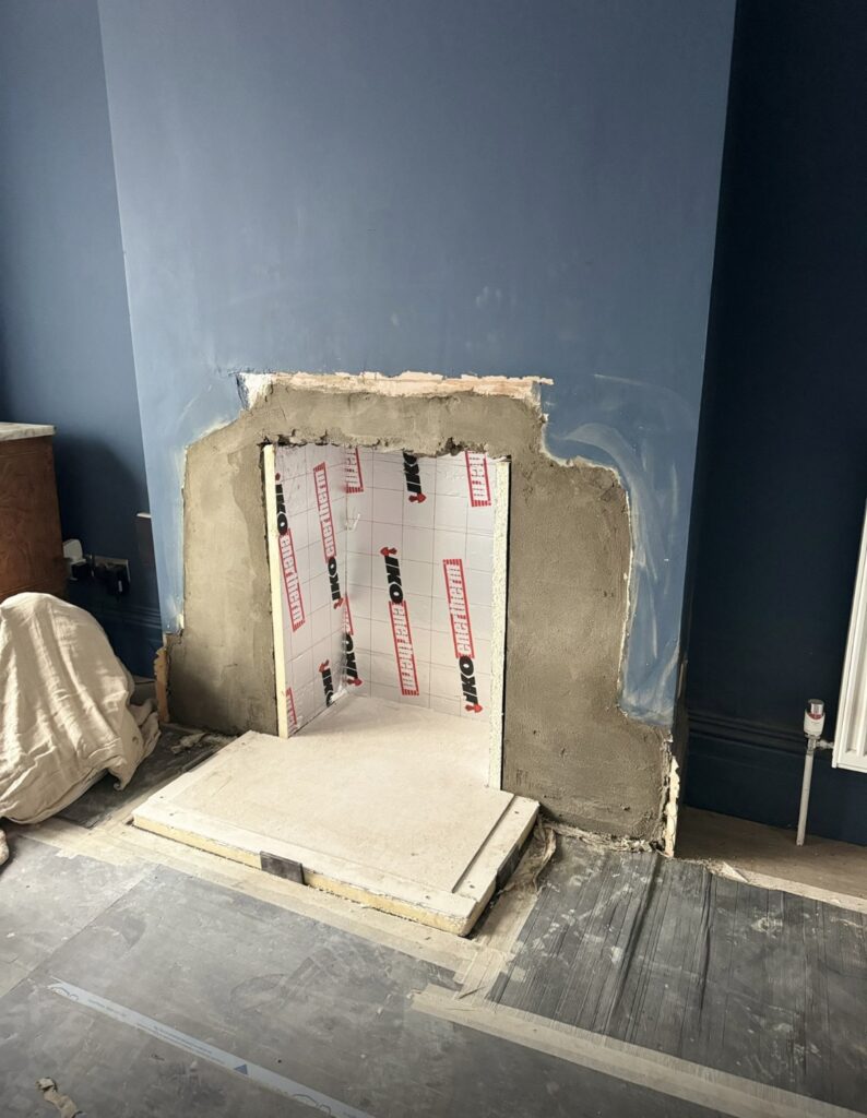 Insulation added to surrounding area of fireplace and chimney to make way for tiles